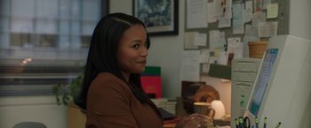 Movie still from “A Journal for Jordan” (2021), directed by Denzel Washington – A woman sitting at a desk in front of papers; Medium shot, Over the shoulder angle