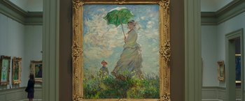 Movie still from “A Journal for Jordan” (2021), directed by Denzel Washington – A painting of a woman holding an umbrella; Wide shot, Low angle