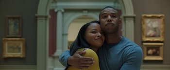 Movie still from “A Journal for Jordan” (2021), directed by Denzel Washington – A man and a woman are posing for a picture; Close Up shot, Low angle