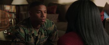 Movie still from “A Journal for Jordan” (2021), directed by Denzel Washington – A man in a military fatigues sitting next to a woman; Close Up shot, Over the shoulder angle