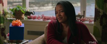 Movie still from “A Journal for Jordan” (2021), directed by Denzel Washington – A woman sitting on a couch in front of a window; Close Up shot, Over the shoulder angle