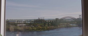 Movie still from “A Journal for Jordan” (2021), directed by Denzel Washington – An oil painting of a bridge over a body of water; Extreme Wide shot, High angle