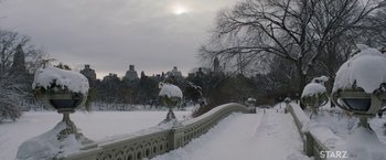 Movie still from “A Journal for Jordan” (2021), directed by Denzel Washington – A snow covered bridge in a park with a view of a city; Extreme Wide shot, High angle