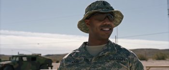 Movie still from “A Journal for Jordan” (2021), directed by Denzel Washington – A man in fatigues is smiling for the camera; Close Up shot, Over the shoulder angle