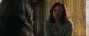 Movie still from “A Journal for Jordan” (2021), directed by Denzel Washington – A woman sitting in front of a mirror in a room; Close Up shot, Over the shoulder angle