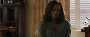 Movie still from “A Journal for Jordan” (2021), directed by Denzel Washington – A woman with her eyes closed in front of a curtain; Close Up shot, Low angle
