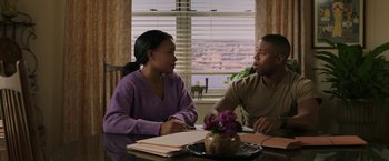 Movie still from “A Journal for Jordan” (2021), directed by Denzel Washington – A man and a woman sitting at a dining room table; Medium shot, Over the shoulder angle