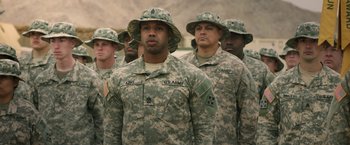 Movie still from “A Journal for Jordan” (2021), directed by Denzel Washington – A group of men in fatigues standing in formation; Medium shot, Over the shoulder angle