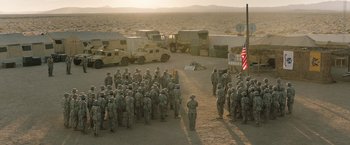 Movie still from “A Journal for Jordan” (2021), directed by Denzel Washington – A large group of soldiers standing in the desert; Extreme Wide shot, High angle