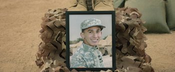 Movie still from “A Journal for Jordan” (2021), directed by Denzel Washington – A picture of a man in a military uniform is in a frame; Close Up shot, High angle