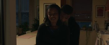 Movie still from “A Journal for Jordan” (2021), directed by Denzel Washington – A young man and a young woman embracing in the dark; Medium shot, Over the shoulder angle