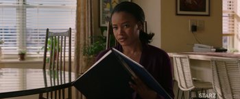 Movie still from “A Journal for Jordan” (2021), directed by Denzel Washington – A woman is holding a book in her hands; Medium shot, Over the shoulder angle