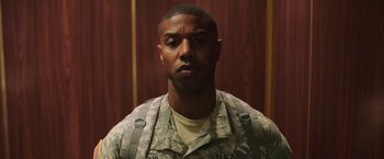 Movie still from “A Journal for Jordan” (2021), directed by Denzel Washington – A man in fatigues is posing for a picture; Close Up shot, Low angle
