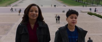 Movie still from “A Journal for Jordan” (2021), directed by Denzel Washington – A woman standing next to a young boy; Medium shot, Low angle