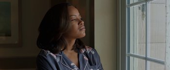 Movie still from “A Journal for Jordan” (2021), directed by Denzel Washington – A woman in a blue and white floral nightshirt; Close Up shot, Low angle