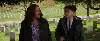 Movie still from “A Journal for Jordan” (2021), directed by Denzel Washington – A woman and a young boy in a cemetery; Medium shot, Over the shoulder angle