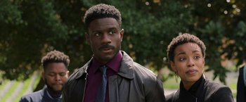 Movie still from “A Journal for Jordan” (2021), directed by Denzel Washington – A man in a leather jacket and a purple shirt; Close Up shot, Over the shoulder angle