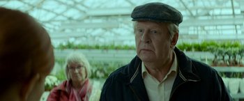Movie still from “A Man Called Ove” (2015), directed by Hannes Holm – An older man and a woman in a greenhouse; Close Up shot, Over the shoulder angle