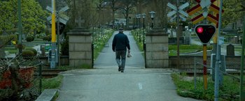 Movie still from “A Man Called Ove” (2015), directed by Hannes Holm – A man walking down a street holding a baseball glove; Wide shot, High angle