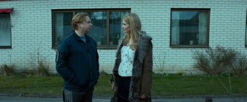Movie still from “A Man Called Ove” (2015), directed by Hannes Holm – A man and a woman standing next to each other; Medium shot, Over the shoulder angle