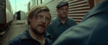 Movie still from “A Man Called Ove” (2015), directed by Hannes Holm – A man with long hair and a goatee is looking at the camera while another man with long hair and a goatee is looking at the camera; Close Up shot, Over the shoulder angle