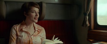 Movie still from “A Man Called Ove” (2015), directed by Hannes Holm – A woman sitting on a bench reading a book; Medium shot, Over the shoulder angle