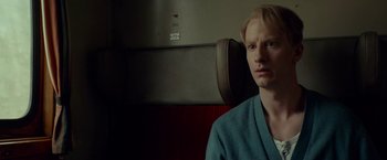 Movie still from “A Man Called Ove” (2015), directed by Hannes Holm – A man sitting on a train looking into the camera; Close Up shot, Over the shoulder angle