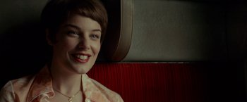 Movie still from “A Man Called Ove” (2015), directed by Hannes Holm – A woman sitting on a train smiling at the camera; Close Up shot, Over the shoulder angle