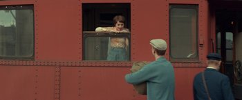 Movie still from “A Man Called Ove” (2015), directed by Hannes Holm – A man standing in front of a woman looking out of a train window; Medium shot, Over the shoulder angle