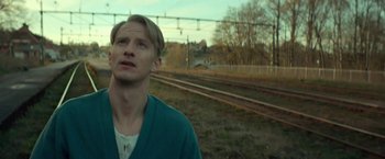 Movie still from “A Man Called Ove” (2015), directed by Hannes Holm – A man standing in front of a train track; Close Up shot, Low angle