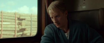 Movie still from “A Man Called Ove” (2015), directed by Hannes Holm – A man with blonde hair sitting in front of a window; Close Up shot, Over the shoulder angle