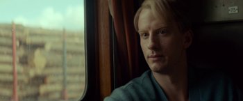 Movie still from “A Man Called Ove” (2015), directed by Hannes Holm – A person sitting on a train window; Close Up shot, Over the shoulder angle