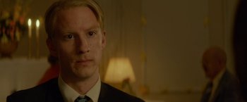 Movie still from “A Man Called Ove” (2015), directed by Hannes Holm – A person wearing a suit and tie; Close Up shot, Over the shoulder angle