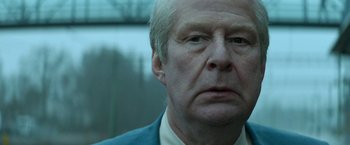 Movie still from “A Man Called Ove” (2015), directed by Hannes Holm – An older man in a blue suit looking at the camera; Close Up shot, Low angle