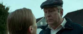 Movie still from “A Man Called Ove” (2015), directed by Hannes Holm – An older man and a young boy talking to each other; Close Up shot, Over the shoulder angle