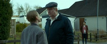 Movie still from “A Man Called Ove” (2015), directed by Hannes Holm – An older man and a younger man are standing outside; Close Up shot, Over the shoulder angle
