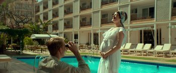 Movie still from “A Man Called Ove” (2015), directed by Hannes Holm – A man taking a picture of a pregnant woman in front of a building; Medium shot, Over the shoulder angle