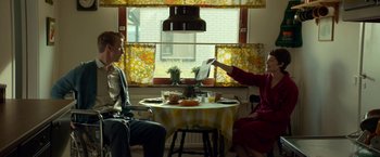 Movie still from “A Man Called Ove” (2015), directed by Hannes Holm – Two people sitting at a table in front of an open window; Medium shot, Low angle