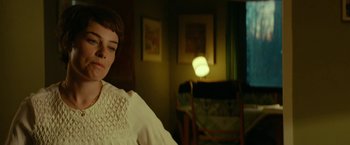 Movie still from “A Man Called Ove” (2015), directed by Hannes Holm – A woman in a white dress sitting in front of a lamp; Close Up shot, Over the shoulder angle