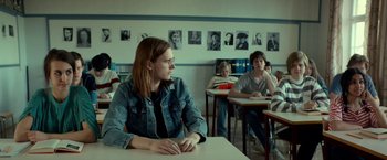 Movie still from “A Man Called Ove” (2015), directed by Hannes Holm – A group of people sitting at a table in a classroom; Medium shot, Over the shoulder angle
