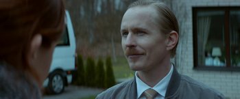 Movie still from “A Man Called Ove” (2015), directed by Hannes Holm – A person wearing a suit and tie; Close Up shot, Low angle