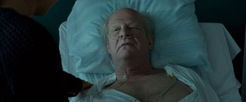 Movie still from “A Man Called Ove” (2015), directed by Hannes Holm – An older man laying in a hospital bed; Close Up shot, High angle