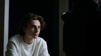 Movie still from “A Man Named Scott” (2021), directed by Robert Alexander – A man sitting in front of a camera in the dark; Close Up shot, Over the shoulder angle