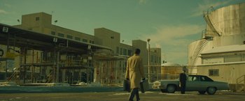 Movie still from “A Most Violent Year” (2014), directed by J.C. Chandor – A man walking down the street holding a suitcase; Extreme Wide shot, Low angle