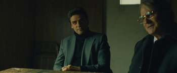 Movie still from “A Most Violent Year” (2014), directed by J.C. Chandor – A man sitting at a table wearing a suit; Medium shot, Low angle