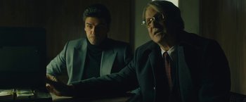 Movie still from “A Most Violent Year” (2014), directed by J.C. Chandor – A man in a suit sitting next to another man in a suit; Medium shot, Over the shoulder angle