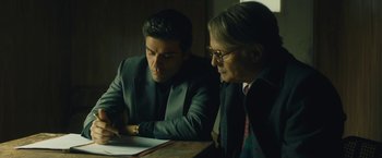 Movie still from “A Most Violent Year” (2014), directed by J.C. Chandor – A man and a woman looking at a piece of paper on a table; Medium shot, Over the shoulder angle
