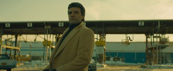 Movie still from “A Most Violent Year” (2014), directed by J.C. Chandor – A man in a brown jacket standing in front of a building; Medium shot, Low angle