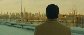 Movie still from “A Most Violent Year” (2014), directed by J.C. Chandor – A man looking out over a city skyline; Close Up shot, Low angle