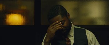 Movie still from “A Most Violent Year” (2014), directed by J.C. Chandor – A man with his hand covering his face; Close Up shot, High angle